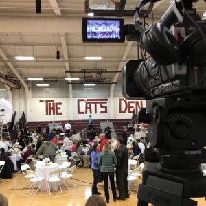 Filming in the high school gym during a special event.